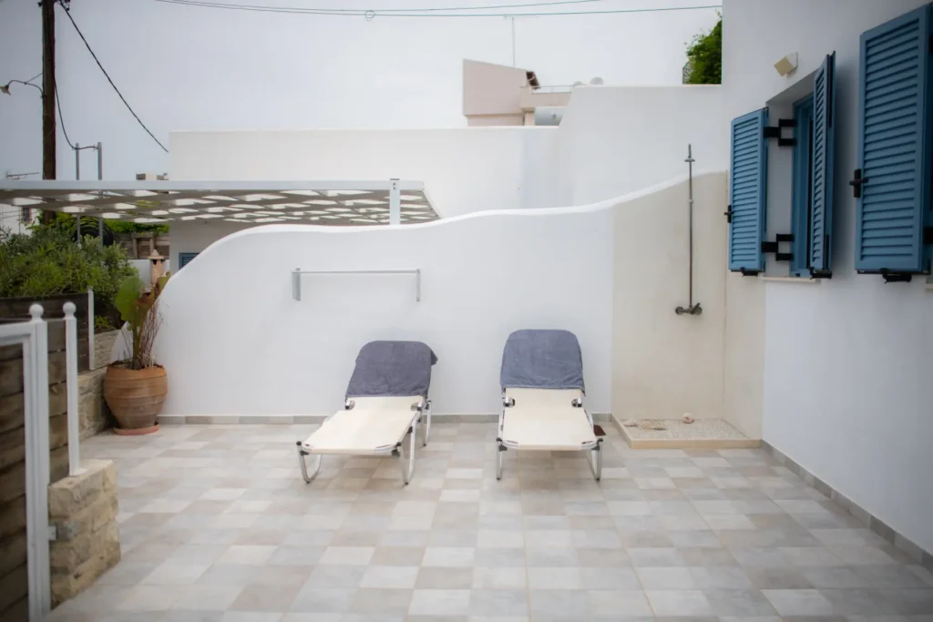 Sunbeds and the outdoor shower in the courtyard